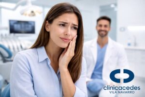 Paciente con sensibilidad dental tocándose la mejilla en clínica dental moderna con dentista al fondo